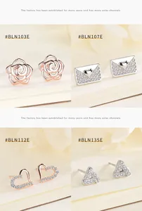 Close-up of four geometric 925 silver stud earrings with rose and heart designs