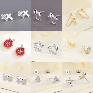Collection of nine minimalist 925 sterling silver stud earrings in various trendy designs