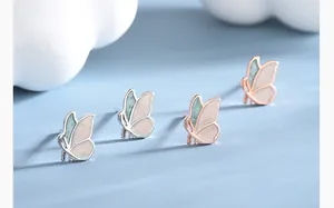 Macro view of sterling silver leaf-butterfly earrings in silver and rose gold finishes