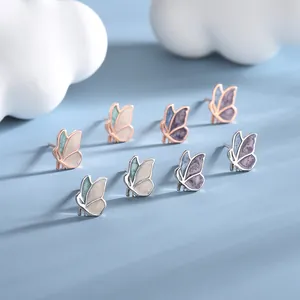 Elegant butterfly stud earrings set in silver and rose gold with enamel gradient wings