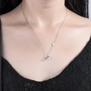 S925 sterling silver whale pendant necklace with heart charm on a female neck