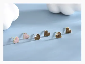 Detail of S925 silver heart stud earrings set with pink and brown marble texture