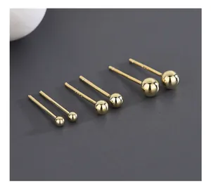 Macro detail of three pairs of S925 sterling silver gold round ball stud earrings set