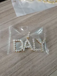 Détail macro du pendentif personnalisé DALY serti de zircons cubiques sur base dorée
