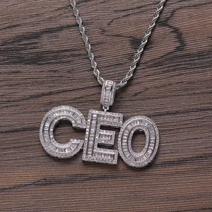 Macro view of silver-toned CEO letter pendant with iced-out cubic zirconia stones