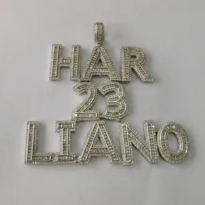 Macro detail of custom silver iced out hip hop pendant with HAR 23 LIANO text engraving