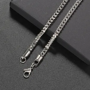 Macro detail of silver wheat chain necklace featuring a secure lobster clasp closure