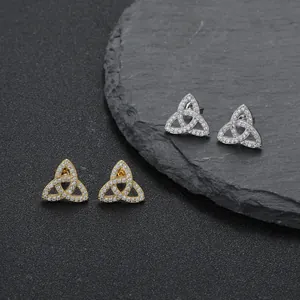 Macro detail of Celtic knot earrings with micro-pave zircons on textured stone base