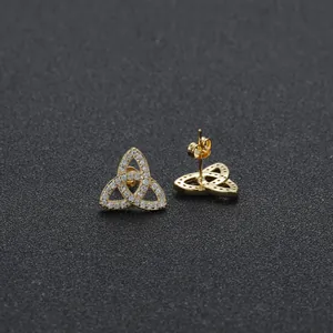 Golden triquetra stud earrings with shimmering cubic zirconia on black display
