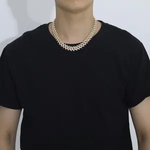 Close-up of 18mm gold iced-out Cuban link necklace with thorns on male model wearing black shirt