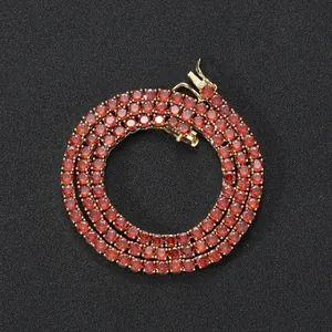 Macro detail of 4mm red zircon tennis chain with gold base and secure safety clasp