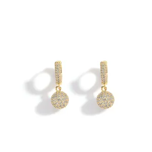 Detail of gold-plated ball drop earrings featuring high-quality micro-pave cubic zirconia