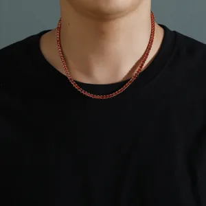 4mm red zircon tennis necklace with gold-plated base worn by male model on black t-shirt