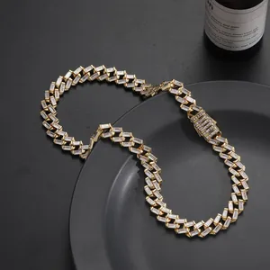 Macro detail of 12mm iced out Cuban chain with baguette cut zircons and gold plating