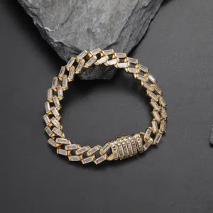 Macro shot of gold hip-hop Cuban link bracelet with iced-out zircon on rock base