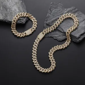 Detailed close-up of 13mm gold Cuban link set with sparkling zircons on rocky background