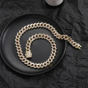 Detail of 12mm gold-plated Cuban link chain with baguette-cut CZ stones on a black texture