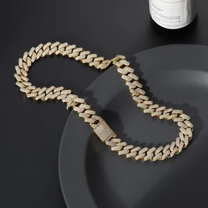 Close-up of golden iced out Cuban link chain with square clasp in a black tray