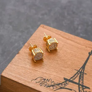Macro detail of gold-plated round stud earrings with shimmering micro-pave cubic zirconia