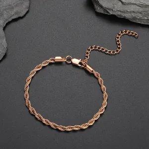 Detail of rose gold rope chain anklet with lobster clasp and extension on dark stone
