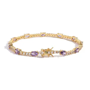 Detail of golden tennis bracelet with oval purple stones and micro-pave white crystals