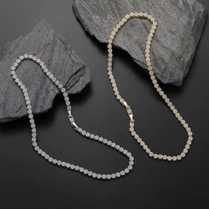 Luxury 5mm gold and silver tennis chains with sparkling zircons on black slate background