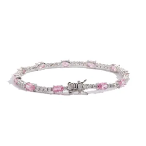 Detail of silver tennis bracelet with oval pink stones and round clear crystals