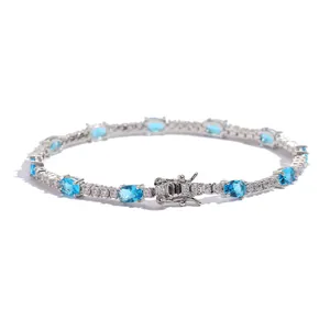 Detail view of oval blue tennis bracelet with silver metal and white zircon stones