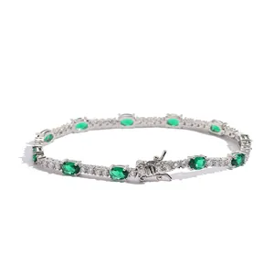 Women's silver tennis bracelet with oval green gemstones and secure box clasp