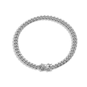 Detail of silver stainless steel Cuban link anklet with a secure box clasp mechanism