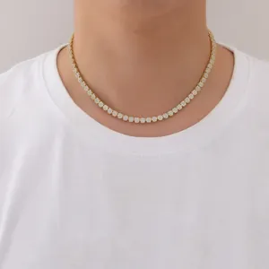 Detailed view of a 5mm gold tennis chain with cubic zirconia on a male model's neck