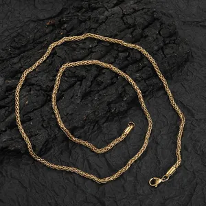 3mm golden stainless steel wheat chain necklace with lobster clasp on dark background