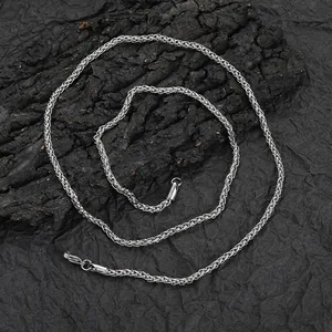 3mm stainless steel wheat chain necklace with lobster clasp on a dark textured background