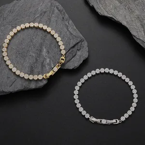 Detail of 5mm gold and silver tennis bracelets with round zircons on dark stone background