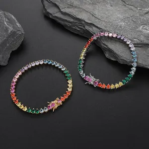 Detail of 4mm rainbow zirconia tennis bracelets in gold and silver finish with secure clasp