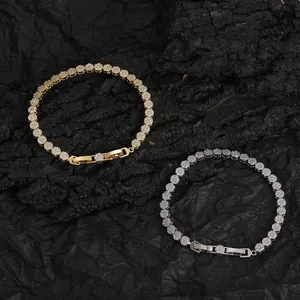 Close-up of gold and silver tennis necklaces with 5mm round cubic zirconia on dark background