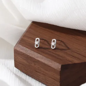Minimalist S925 sterling silver paperclip earrings with cubic zirconia on a wooden stand