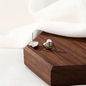Rainbow striped heart studs in S925 sterling silver on a walnut display stand