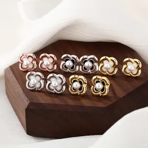 Hollow camellia flower stud earrings with pearls in gold, silver, and rose gold finishes