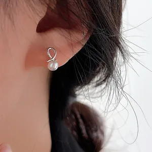 Elegant S925 sterling silver pearl stud earrings with minimalist twist design for women