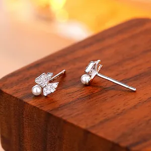 Elegant S925 silver bow stud earrings with sparkling cubic zirconia and white pearls