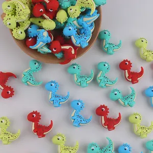 Vista detallada de cuentas de silicona con forma de dinosaurio para accesorios de dentición