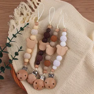 Detail of handmade pacifier clips with beech wood bear heads and assorted silicone beads