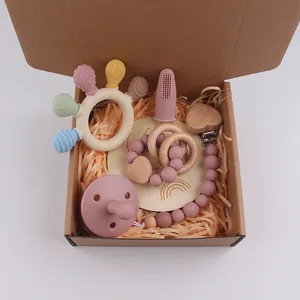 Silicone and wood baby teether gift set in a kraft box with a rattle and pacifier clip
