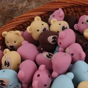 Macro detail of cartoon bear silicone beads in various colors for DIY craft jewelry making