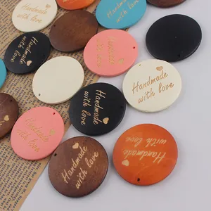 Detailed view of colorful wooden round tags with Handmade with Love engraving for DIY crafts