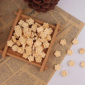 Close-up of cream flower wooden beads with side holes for DIY jewelry making and crafts
