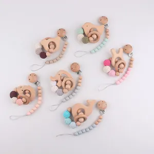 Detail of wooden teething rings and silicone bead clips in soft Morandi colors