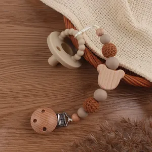 Detail of beech wood bear clip with crochet beads and food-grade silicone pacifier