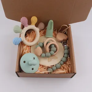 Silicone baby teether gift set with pacifier and wooden clip in a craft paper box